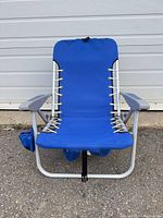 Front view of blue folding beach chair showing fabric seat, laced sides and cup holder pouch