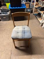 Front view of wooden chair with cushion attached