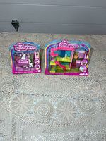 Front view of two sealed Mini Barbie Land packages