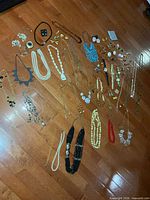 Floor layout showing entire assortment of necklaces, earrings, brooches, rings and watches