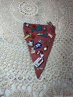 Full view of triangular cardboard with all lapel pins attached