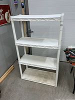 Front view of white four-shelf resin storage unit