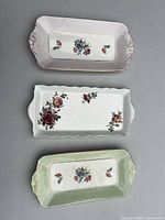 Group shot of three floral bone china trays showing overall style and colors