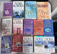 Front view of all 14 Nora Roberts paperback novels