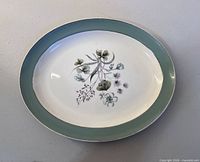 Top view of oval platter showing teal rim and floral center