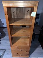 Front view of solid pine bookcase showing three shelves and two drawers
