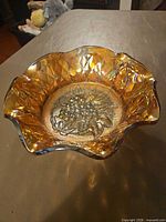 Top view of amber carnival glass bowl showing ruffled edge and interior pattern