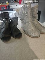 Pair of silver rhinestone boots and dark grey ankle booties side by side