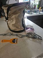 Full lot showing lift bucket, chain with hooks, adhesive spreader, sealed P100 filters