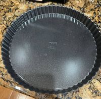 Top view of round fluted pan showing nonstick interior and fluted sides
