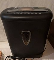 Front view of shredder showing black bin and silver trim