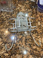 Top view of metal caddy showing plastic iron rest tray and adjustable arms