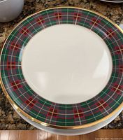 Stack of Lenox Tartan dinner plates showing plaid rim and gold trim