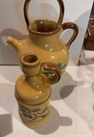 Pitcher and cruet side by side showing form and decoration