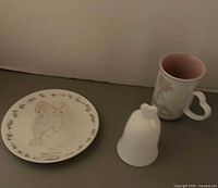 Plate, bell and mug grouped together