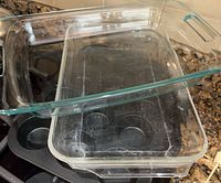 Nested clear glass baking dishes atop muffin pan