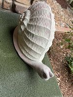 Full view of snail statue left side on artificial turf