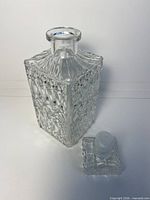 Decanter separated from stopper showing opening and cut pattern