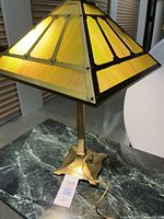 Full view of lamp on table showing shade, column, base and cord
