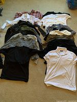 All 15 shirts laid out showing variety of styles and colors