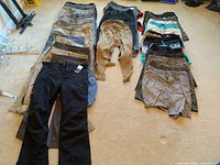All items laid out showing three columns of pants, shorts and swimwear