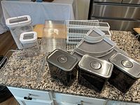 Group shot showing all canisters, trays, lazy-susans, and wire risers on countertop