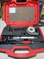 kit in red carry case showing all components neatly arranged