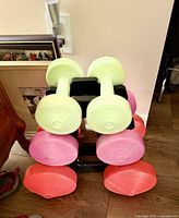 Front view of dumbbell rack with six vinyl dumbbells