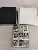 Black and white binders with card pages visible