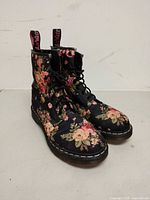Front and side view of both boots showing floral canvas uppers and laces