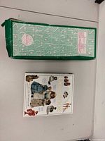 Green Madame Alexander box and front cover of The Ultimate Doll Book