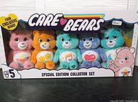 Front of sealed box showing five plush Care Bears
