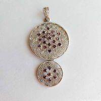 Front view of dual round filigree pendant with purple stones