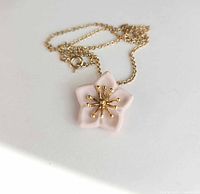 Front view of ceramic flower pendant and chain