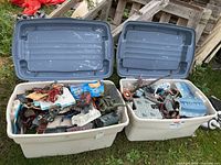 Two open Rubbermaid totes filled with Mega Bloks parts and figures