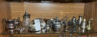 Overall view of silver-plated tableware assortment on shelf