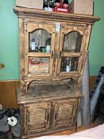 Full view of two-piece cabinet showing upper glass doors and lower paneled doors