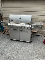 Front view of Weber stainless 6-burner propane grill with lid closed