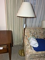 Full view of lamp beside sofa