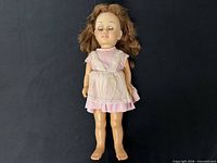 Full frontal view of Chatty Cathy doll wearing dress and apron
