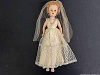 Full view of bridal doll with veil and dress