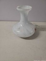 Front view of white vase with red spots
