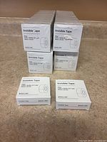 Front view showing stacked sealed Baseline Invisible Tape boxes