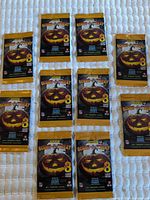 Top view of 10 sealed Panini Score-A-Treat packs laid out on quilt surface