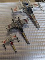 Three X-Wing starfighters in different scales