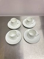 Four cup and saucer sets displayed top view