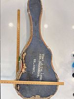 Full view of worn blue cloth guitar case with U.S. Army stencilling