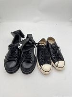 Both sneaker pairs side by side