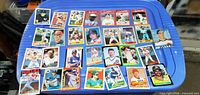 All twenty Score baseball cards laid out on blue surface