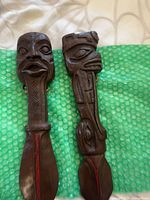 Both carved wood wall hangings side by side showing overall design, size and color